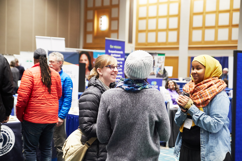 2018 Community Connections Conference exhibit hall visitors conversing