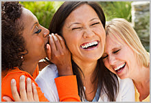 Group of 3 women laughing.