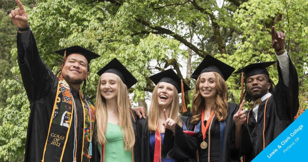 5 college graduates from Lewis & Clark College stand together in caps and gowns, smiling.