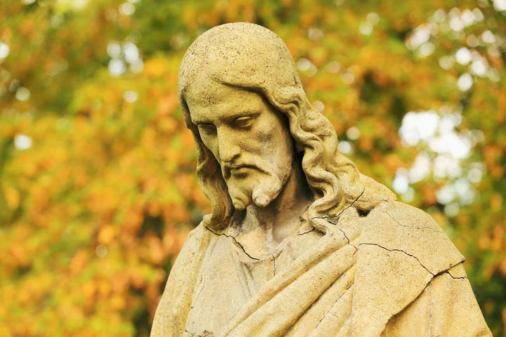 a close up of a person standing in front of a tree: A Florida statue of Jesus Christ, similar to this one, was beheaded by an unknown culprit.