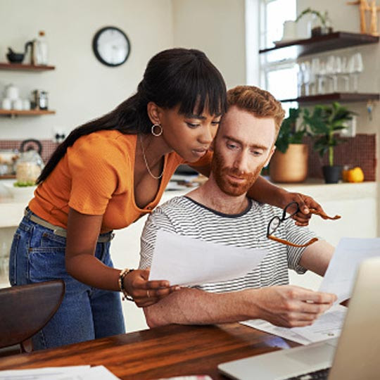 A couple at their computer, working on finances