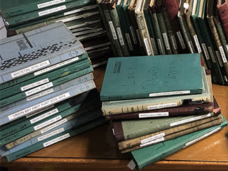 Logbooks from the cabins and yurts at Porcupine Mountains Wilderness State Park are shown.