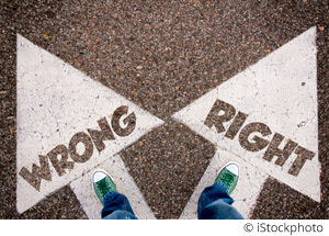 Wrong and right dilemma concept with man legs from above standing on signs.