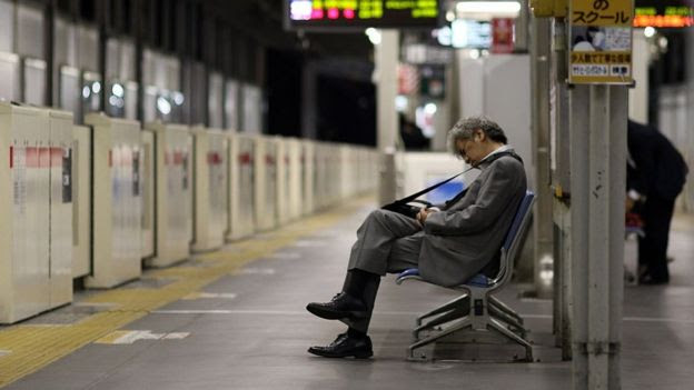 Homem com roupa formal dorm em estação de metrô
