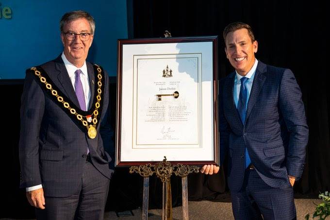 James Duthie holding the Key to the City award.