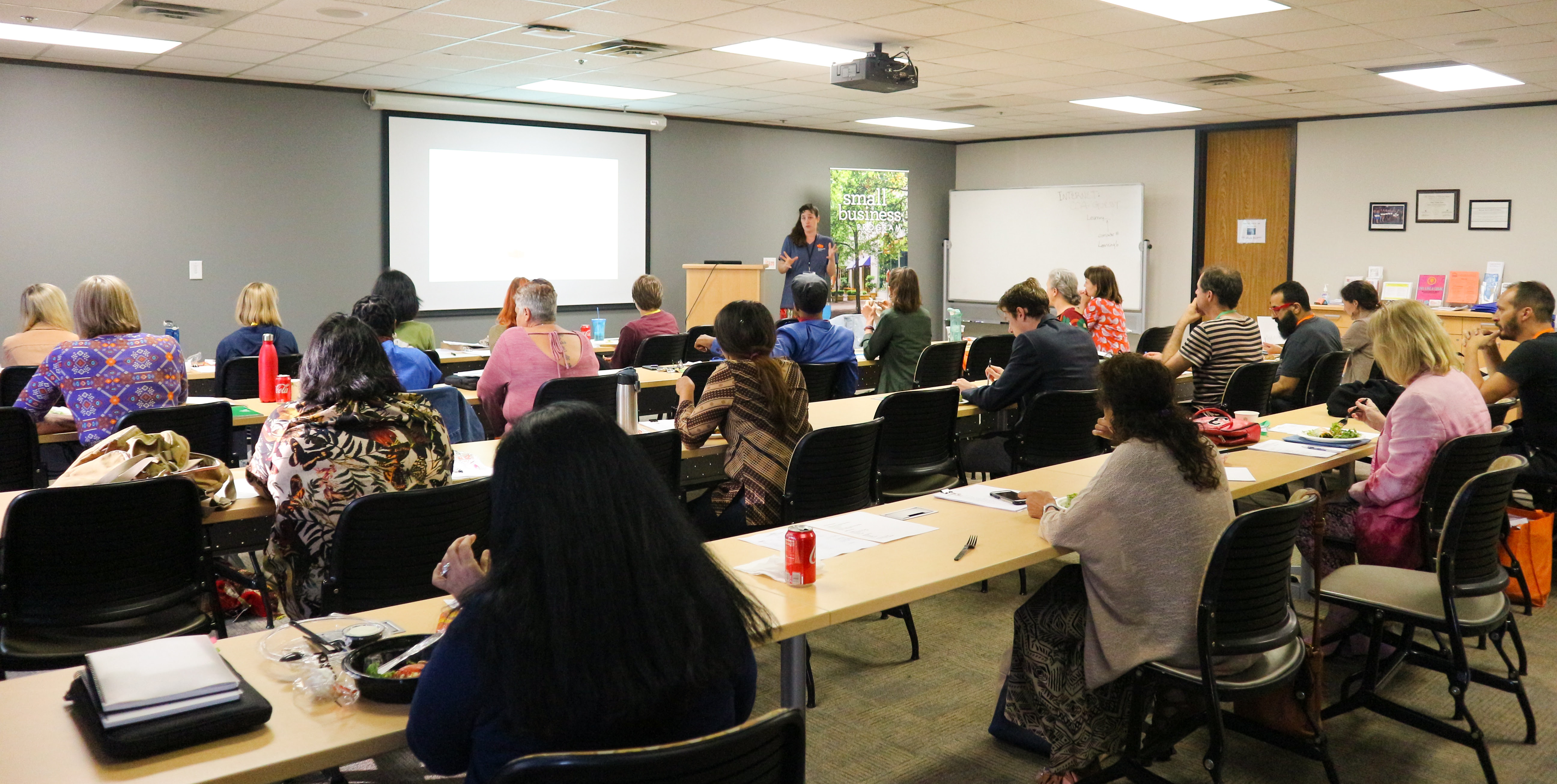 Classroom of students attending Artist Career Training, looking forward at instructor
