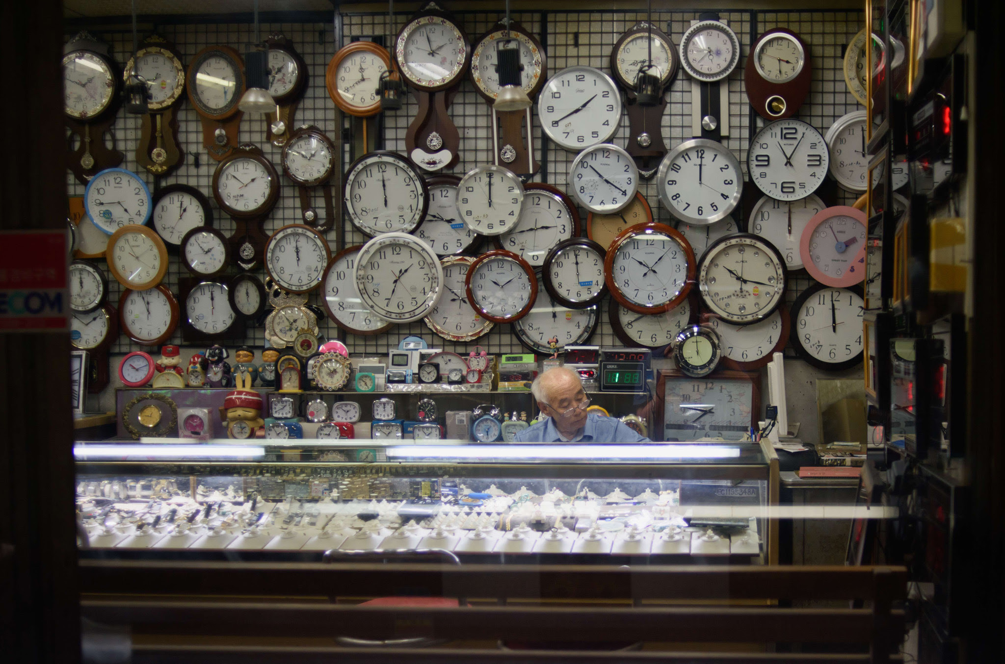 A watch and clock vendor sits in his shop in Seoul, South Korea.