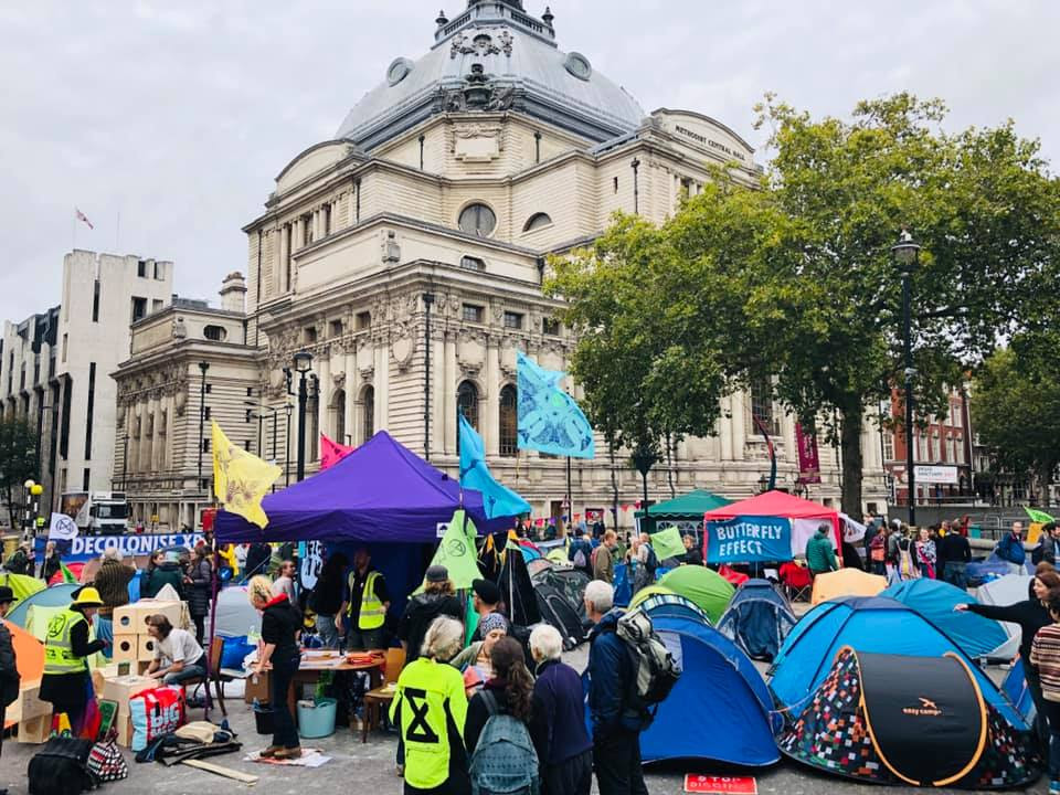 Power In Truth site, with numerous colourful tents, gazebos and flags.