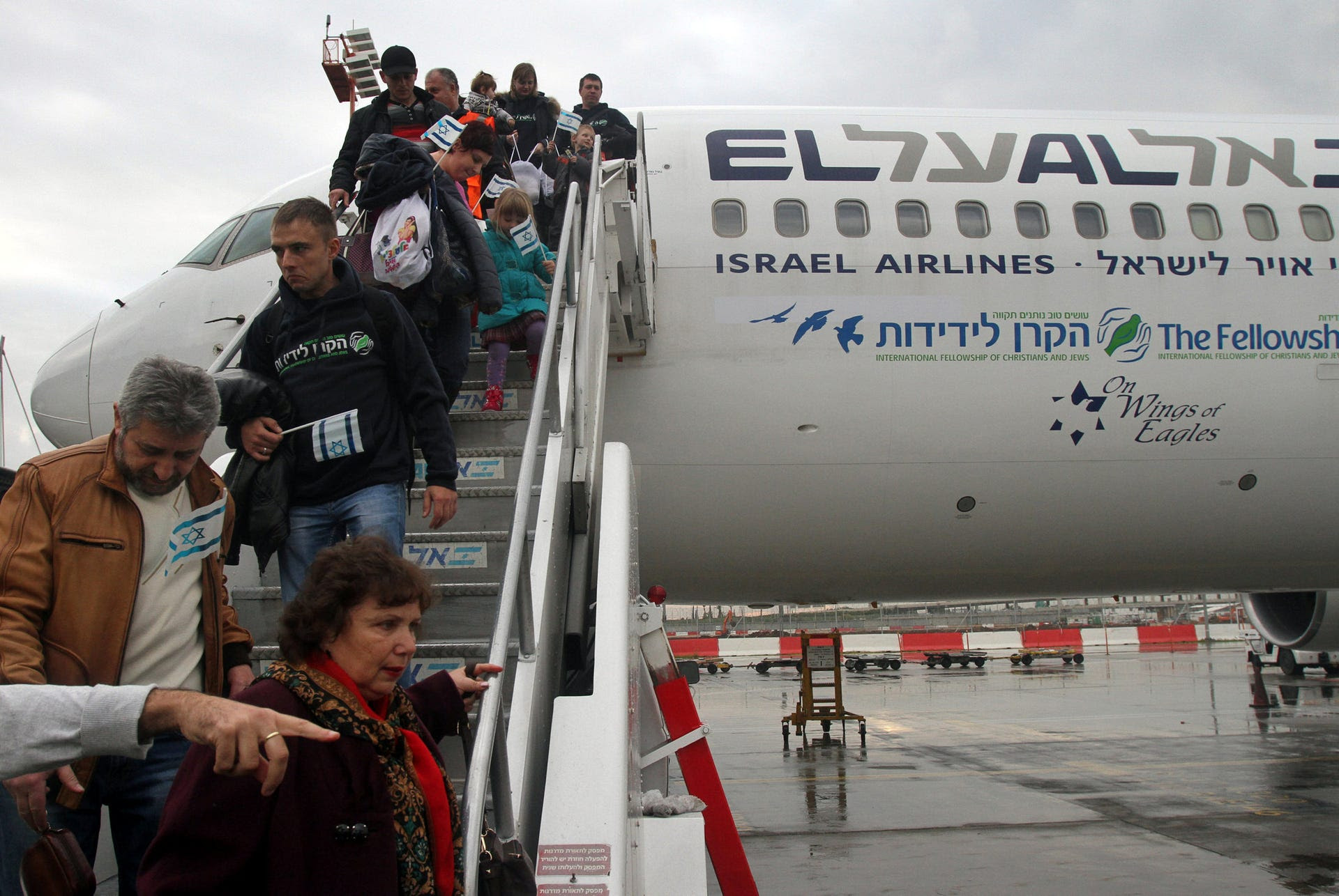 Jewish immigrants from Ukraine making Aliyah walk down the stairs as their airplane lands at Ben Gurion International airport, December 22, 2014.
