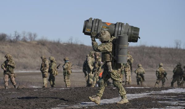 A Ukrainian serviceman carries an NLAW anti-tank weapon during an exercise in the Joint Forces Operation, in the Donetsk region, eastern Ukraine, Tuesday, Feb. 15, 2022. While the U.S. warns that Russia could invade Ukraine any day, the drumbeat of war is all but unheard in Moscow, where pundits and ordinary people alike don&#39;t expect President Vladimir Putin to launch an attack on its ex-Soviet neighbor. (AP Photo/Vadim Ghirda)