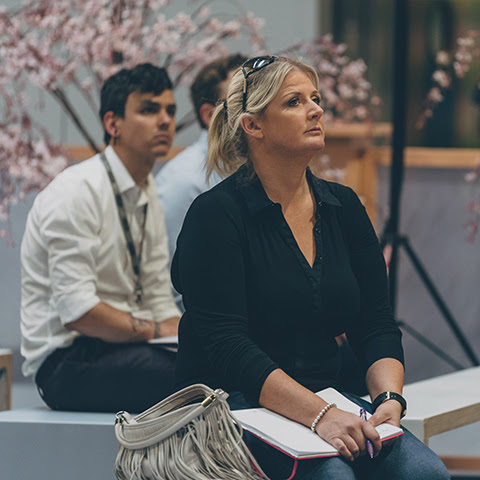Woman enjoying a speaker.jpg