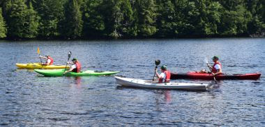 people kyaking on a lake