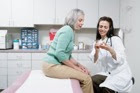 Photograph of a female doctor discussing medication with a female patient Photograph of a female doctor discussing medication with a female patient