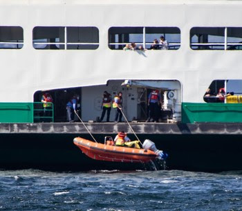 Photo of rescue boat being deployed from the ferry Puyallup