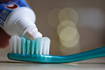 Toothpaste-on-brush-flick