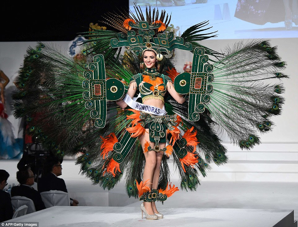 Miss Honduras Jennifer Valle displays her national costume during the Miss International beauty pageant in Tokyo. She opted for peacock feathers for her green and orange outfit, despite the national bird of Honduras being the colourful scarlet macaw