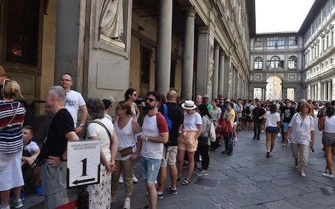 A queue of tourists outside the Uffizi Galleries in Florence - one of the world's most acclaimed art galleries