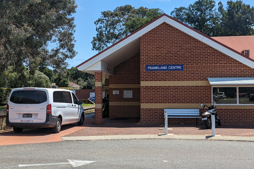 The brick exterior of the Frankland Centre with a van labelled "security" parked outside.