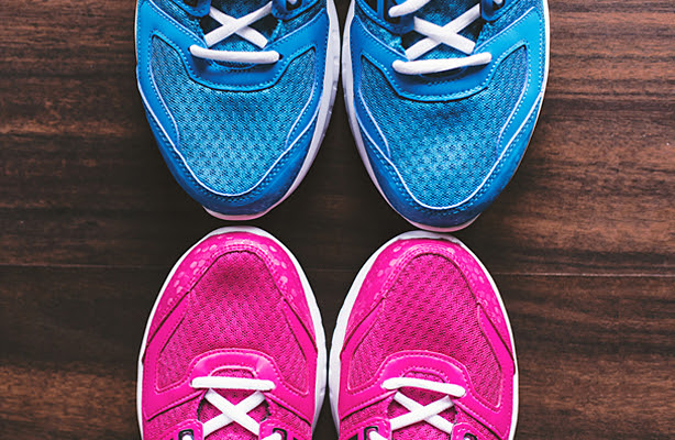 A pair of blue sneakers above a pair of pink sneakers.