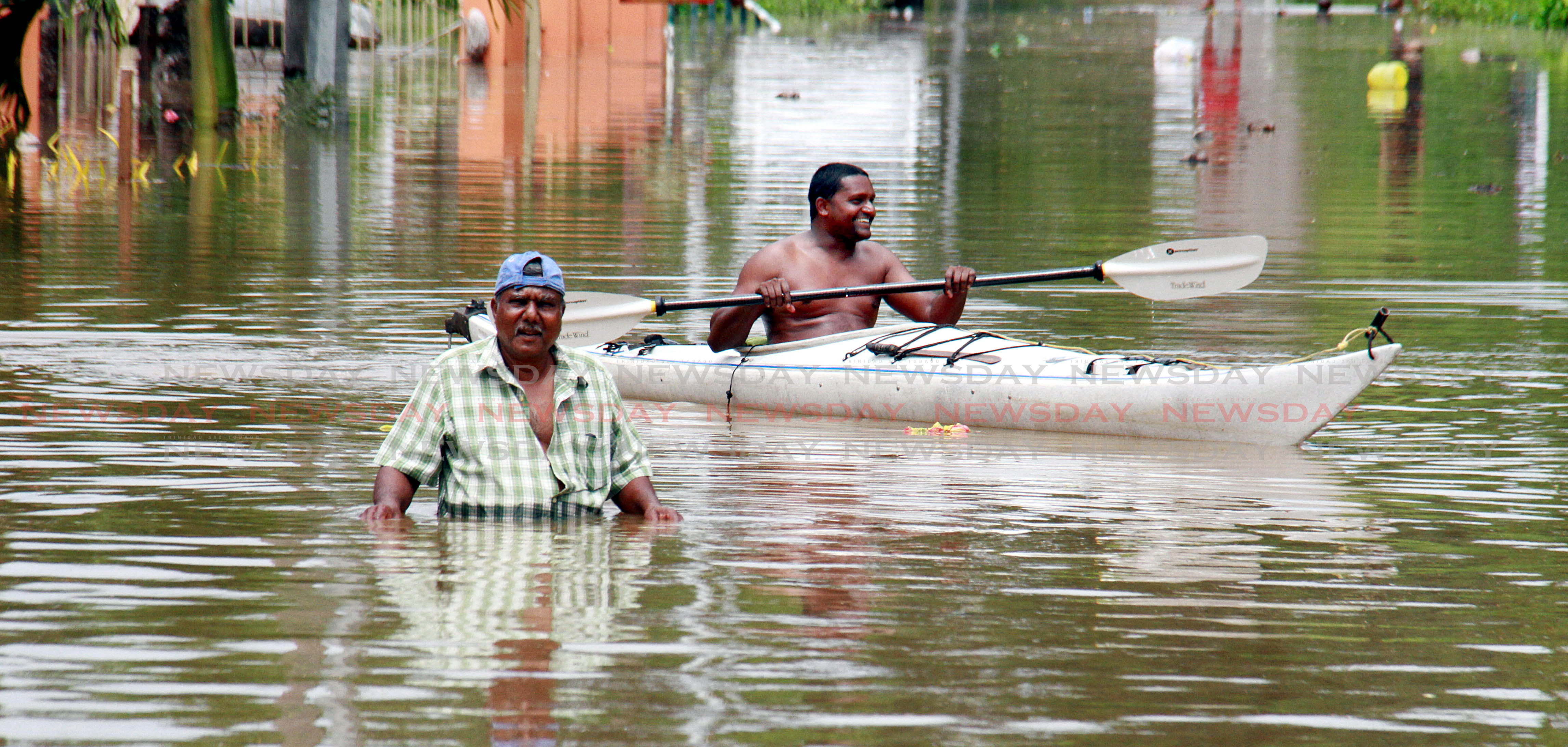 Mayaro residents have to leave there homes to safer grounds after heavy rains caused massive flooding on Saturday. PHOTO BY ANIL RAMPERSAD