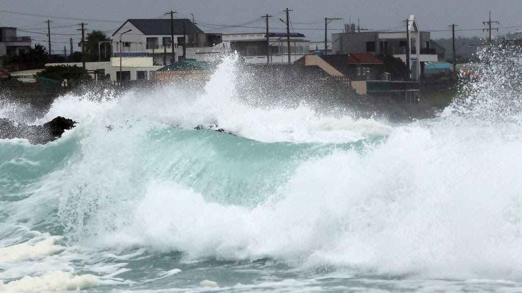 waves crash in South Korea as a tropical storm approaches.