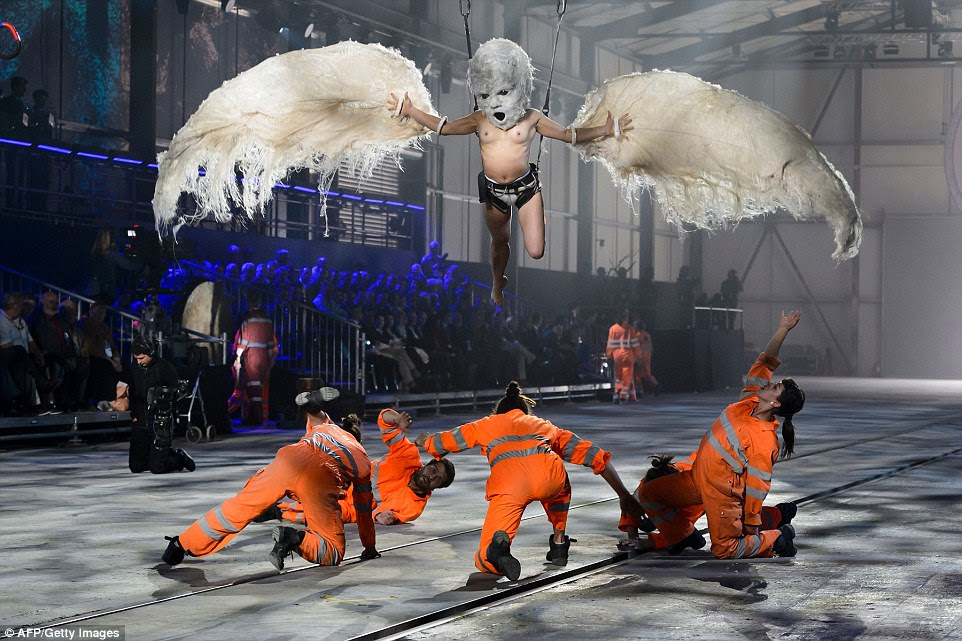 Flying baby: The Swiss have put on one of the most bizarre opening ceremonies in history to mark the completion of the world's longest tunnel