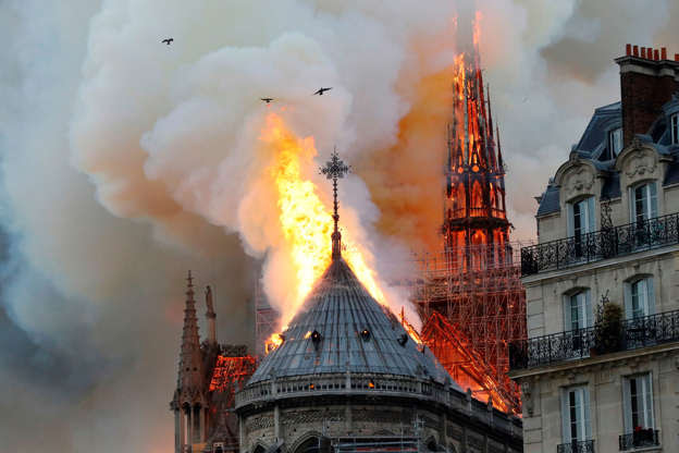 Slide 27 of 31: Smoke and flames rise during a fire at the landmark Notre-Dame Cathedral in central Paris on April 15, 2019, potentially involving renovation works being carried out at the site, the fire service said. (Photo by FRANCOIS GUILLOT / AFP) (Photo credit should read FRANCOIS GUILLOT/AFP/Getty Images)