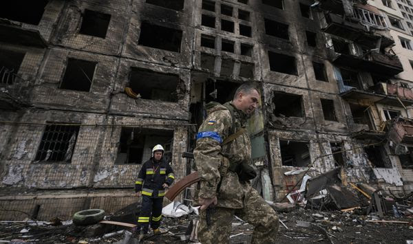 Ukrainian soldiers and firefighters search in a destroyed building after a bombing attack in Kyiv, Ukraine, Monday, March 14, 2022. (AP Photo/Vadim Ghirda)