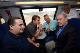 PM Netanyahu, Transportation Minister Katz, and the mayors of the southern towns on a train.