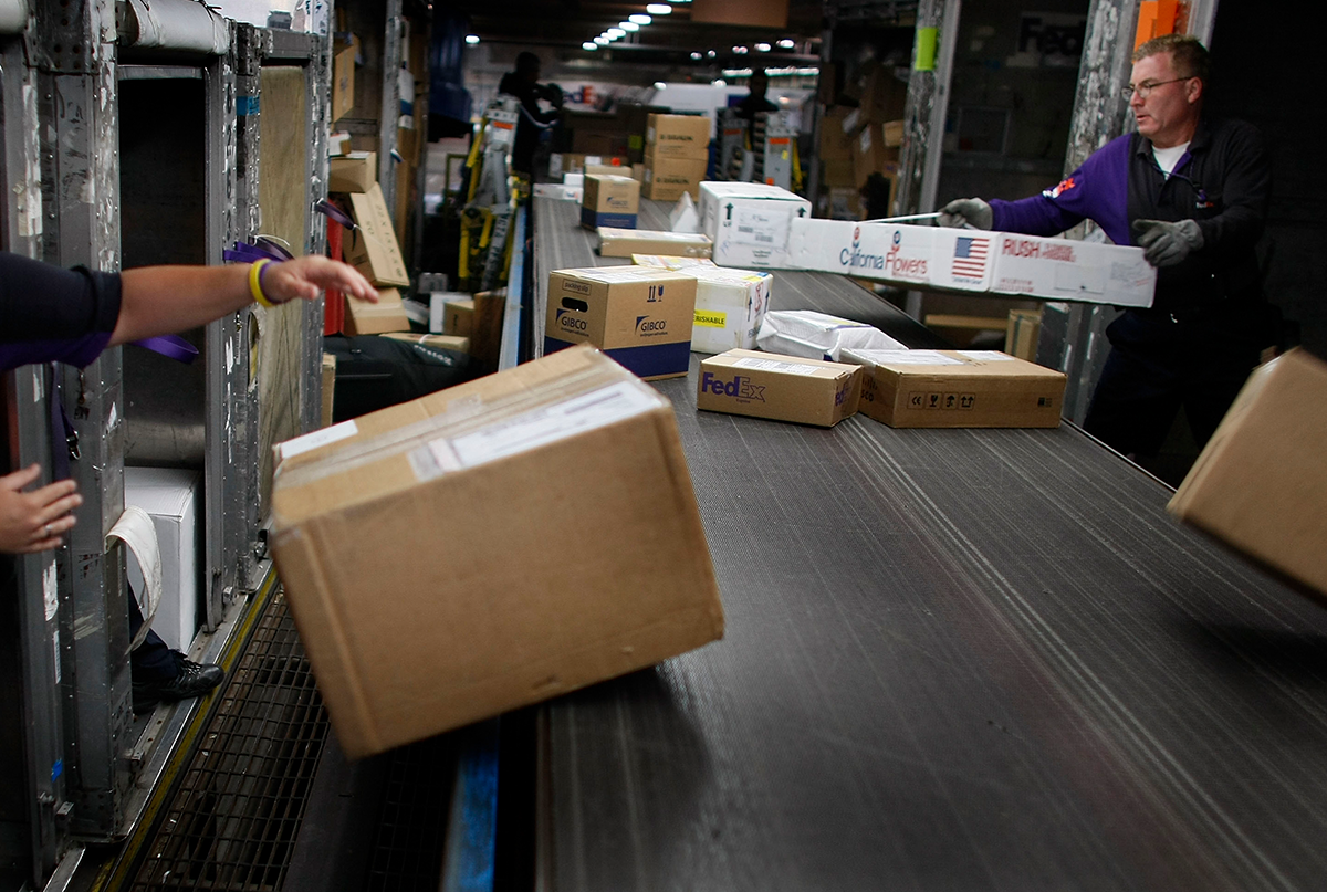 FedEx workers sorting packages