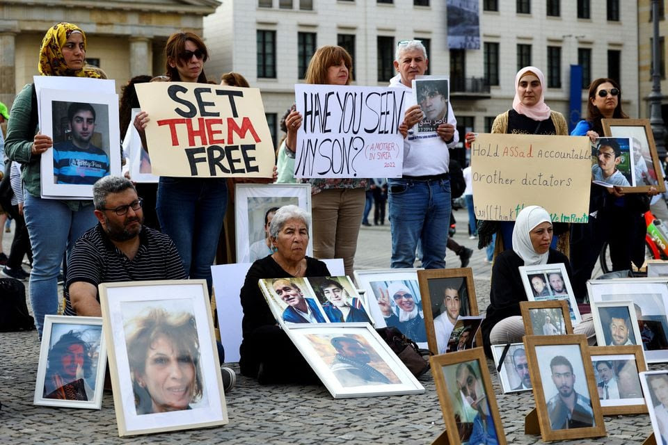 People take part in a sit-in protest organized by Syrian activists, calling for the release of political detainees after an amnesty decree by Syrian President Bashar al-Assad, in Berlin, Germany, May 7, 2022. REUTERS/Christian Mang