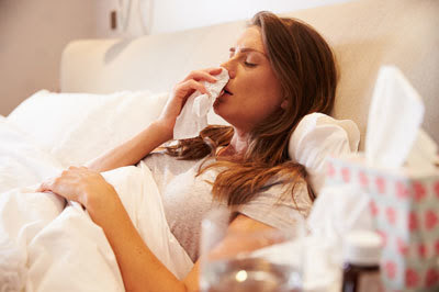 woman sick in bed with flu