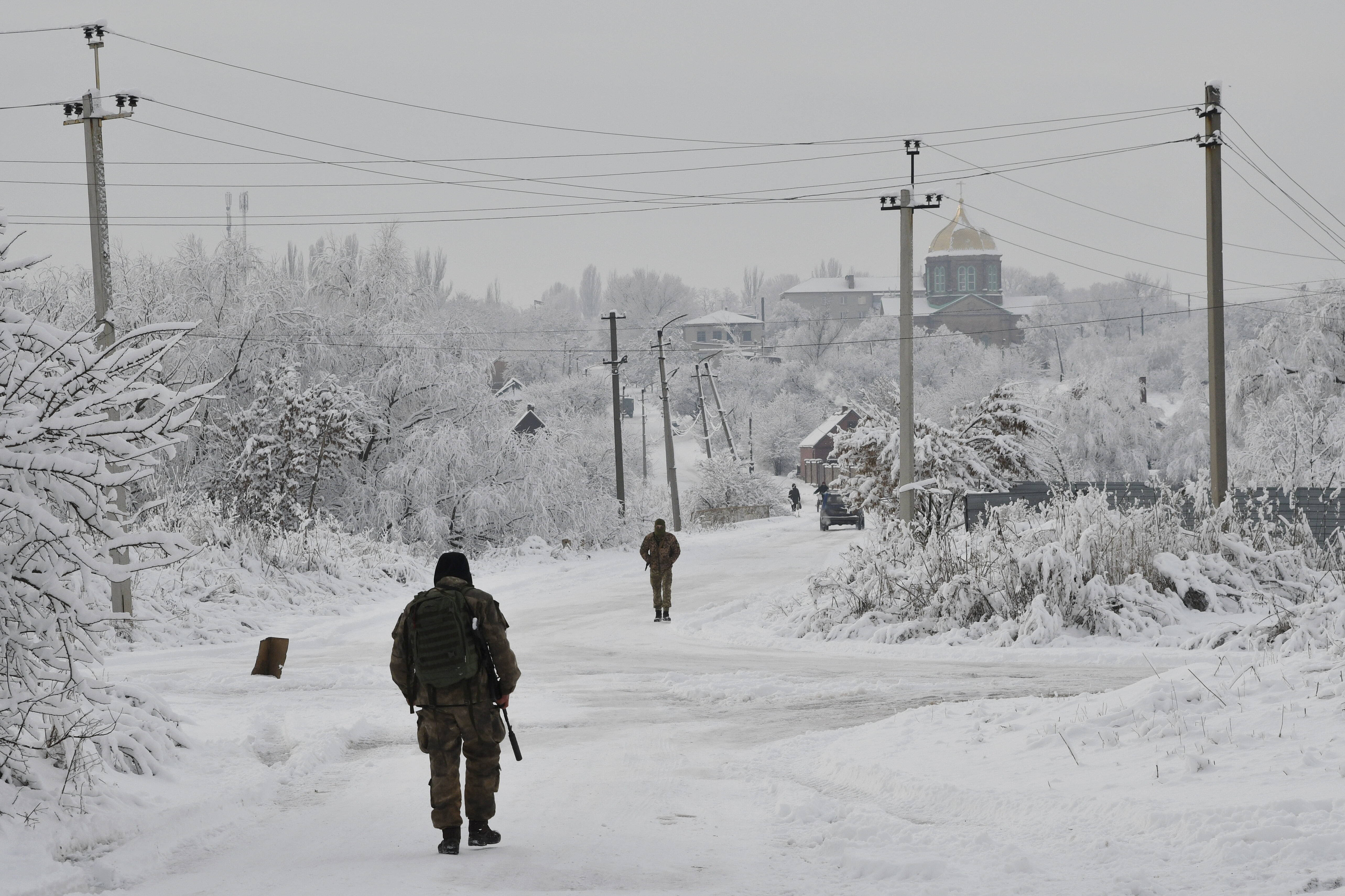 Ukrainian servicemen patrol Verkhnotoretske village near the front line with Russia-backed separatists in the Yasynuvata district of the Donetsk region in eastern Ukraine on Dec. 27. (Andriy Andriyenko/AP)