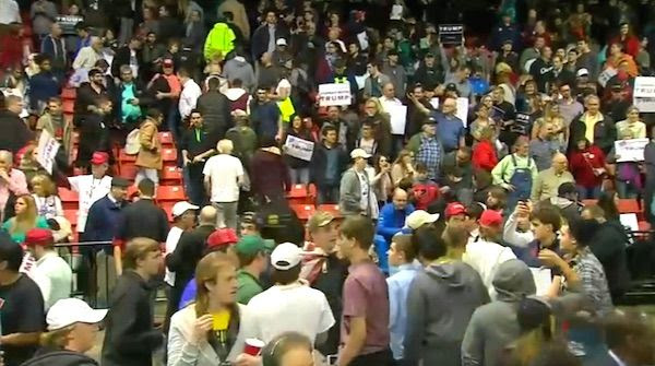 A stunned crowd of Donald Trump supporters loiters inside the University of Illinois-Chicago Pavilion after a security threat ended a political rally (Photo: NBC 5 Chicago screenshot)